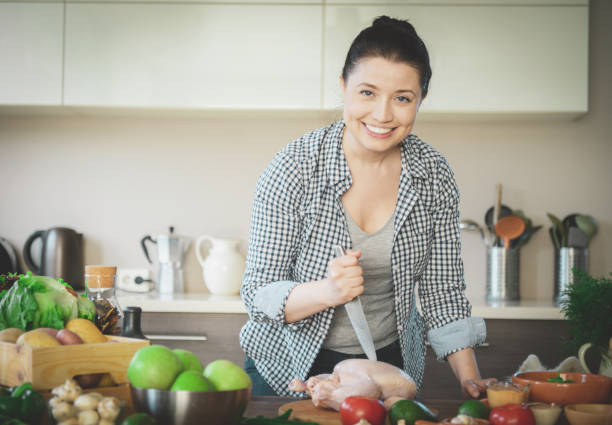 istock woman in the kitchen preparing food 1219948092