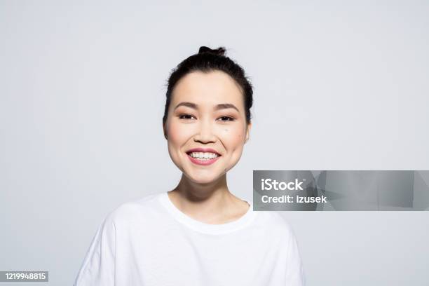 Headshot Of Happy Asian Young Woman Stock Photo - Download Image Now - Human Face, Studio Shot, Asian and Indian Ethnicities