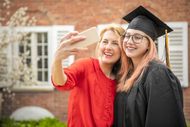 istock Mother Taking Selfie With Graduate Daughter 1219949769