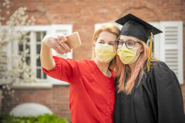 Photo of Pandemic Grad Mother and Daughter Selfie