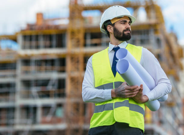 istock Confident architect holding blueprint and looking away 1219950008