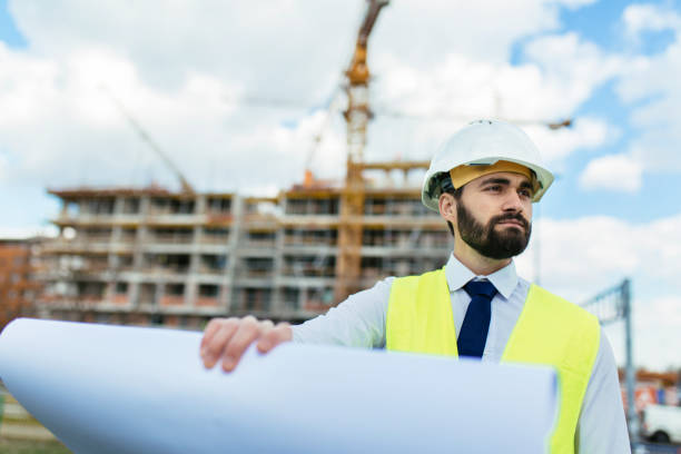 istock Construction manager holding blueprint and looking away 1219950468