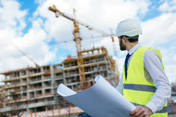 istock Mid adult architect looking toward construction site 1219952502