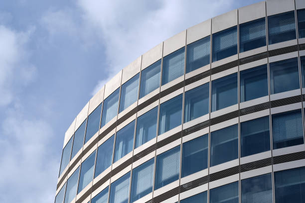 Close-up of modern office building against sky stock photo