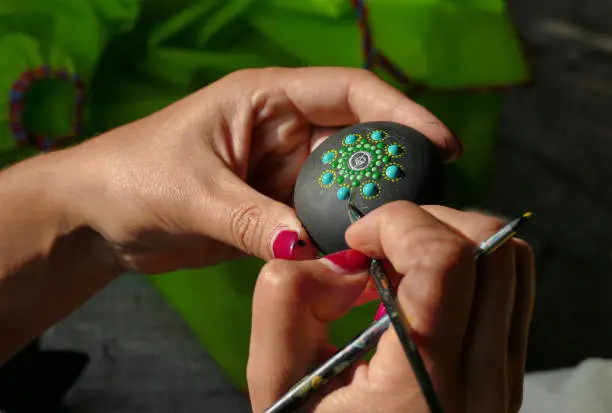 Painting and decoration of a stone with the multiform painting technique