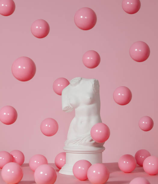 Plaster torso of Venus surrounded by flying pink spheres