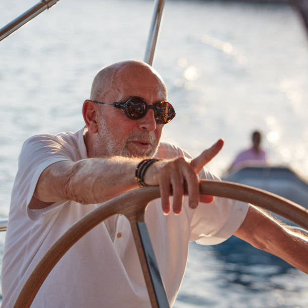 istock Mature man sailing yacht. 1219958060