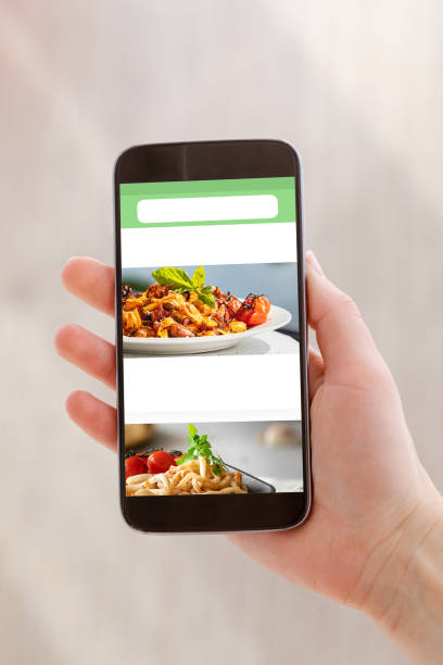 istock Mobile with white blank screen in woman hand on light background. Clipping path screen. 1219958400