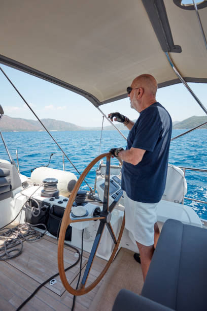 istock Mature man sailing yacht. 1219958716