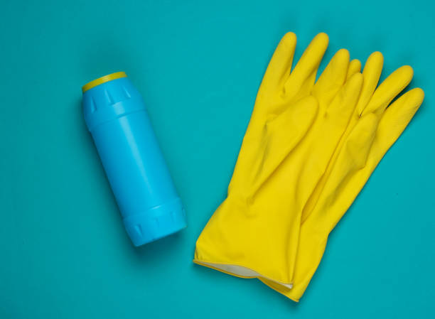 istock Bottle for cleaning, gloves on blue background. Top view. Minimalism 1219959841