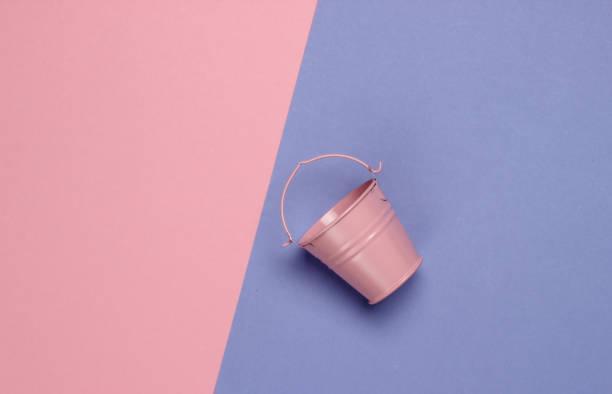 istock Pink empty mini bucket on colored pastel background. Minimalism. Trend color concept. Top view 1219960137