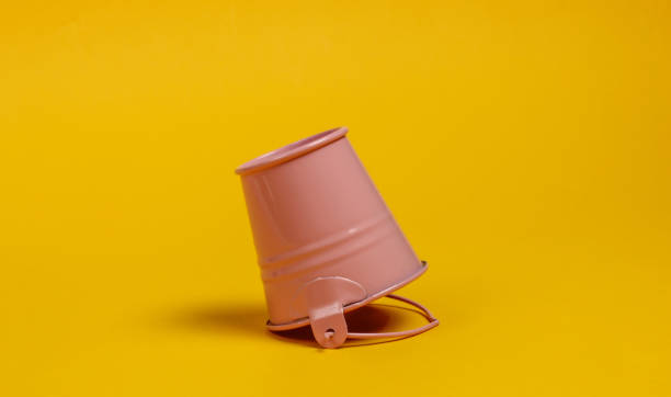 istock Inverted mini bucket on a yellow background close-up 1219960261