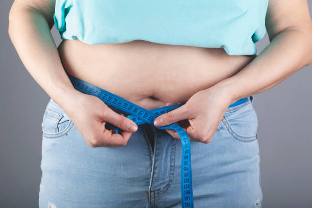 istock woman hand meter in belly 1219961301