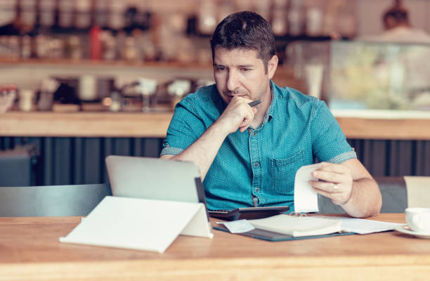 Start-up entrepreneur concerned about financial reports stock photo
