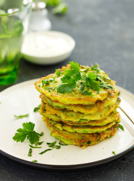 istock Fritters from zucchini and greens with poached egg. Healthy breakfast. Selective focus 1219961606