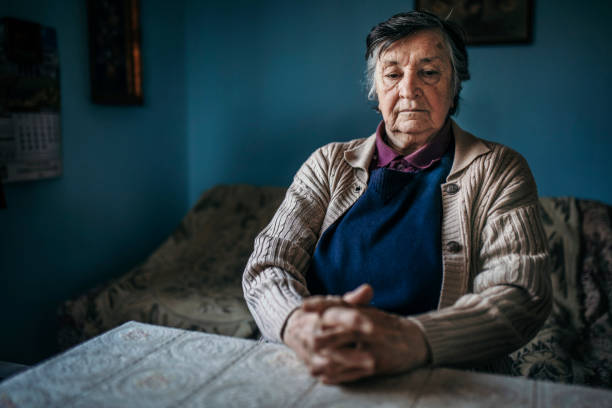 istock Depressed senior woman sitting alone 1219963401