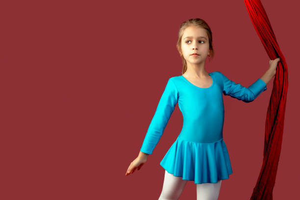 istock Charming little girl in a blue gymnastic suit 1219963553