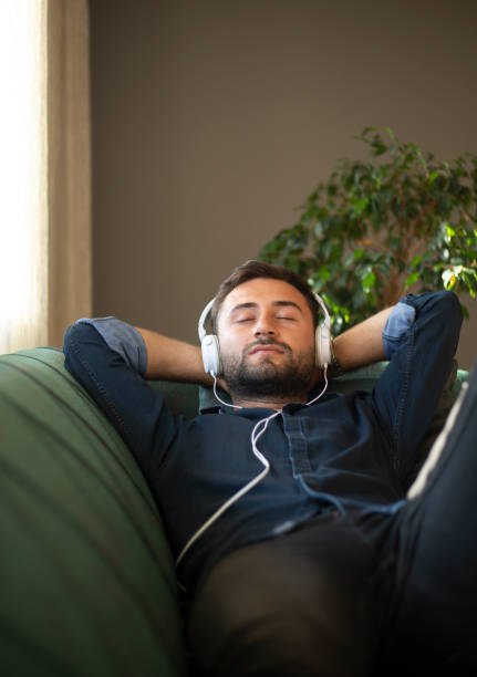 istock Man on his sofa listening to music with a tablet 1219963939