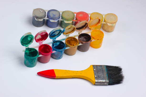 istock Gouache bottles of paint with brush on white background. 1219963967