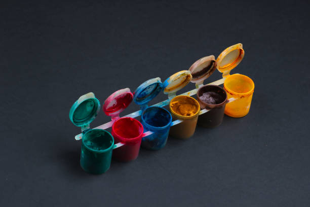 istock Gouache bottles of paint on black background. 1219964016