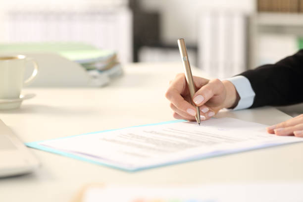 istock Executive woman hand signing contract in the office 1219964117