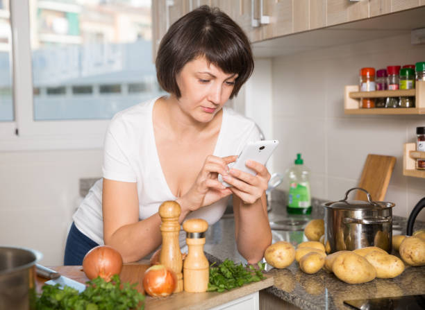 istock Housewife using her mobile phone 1219965967