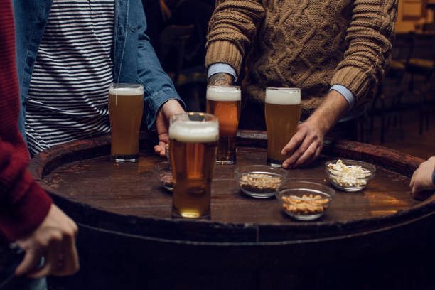 istock Beer and Snacks: Group of Unrecognizable  Men at the Bar Together, a Close Up 1219967622