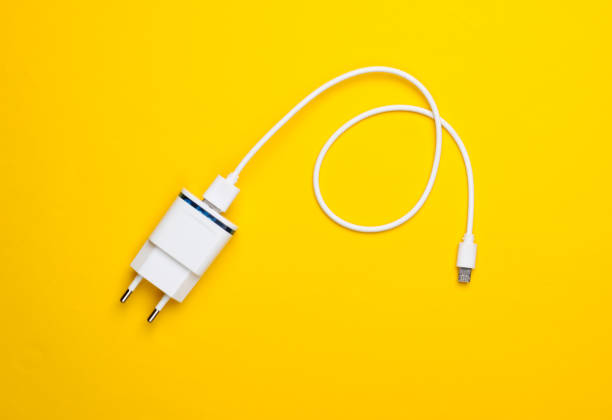 istock Charger with cable on a yellow background. Top view 1219967780