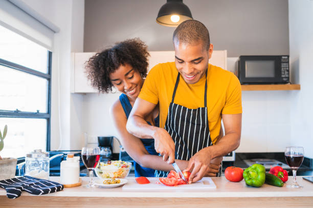 istock Latin couple cooking together in the kitchen. 1219967992