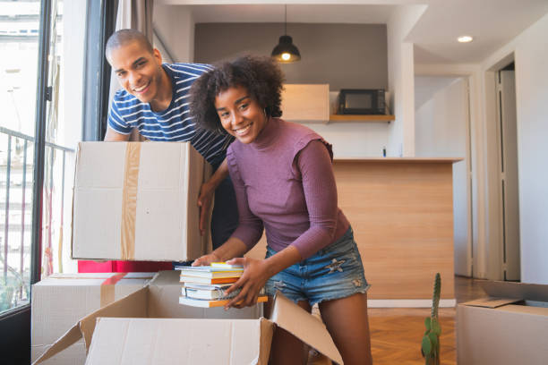 istock Latin couple unpacking at their new house. 1219967997