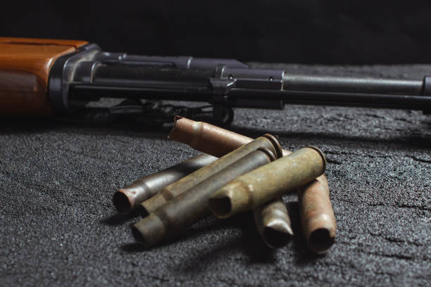 istock old rusty spent cartridges and a gun barrel on black concrete 1219968841