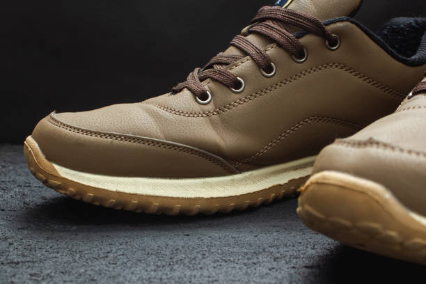 istock light brown leather sneakers on black concrete 1219969455