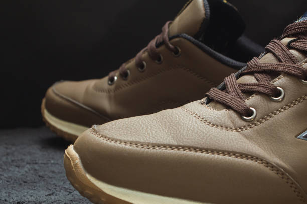 istock light brown leather sneakers on black concrete 1219969496