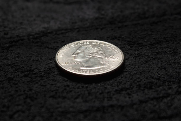 istock quarter dollar on black concrete dark background .copy space 1219970685