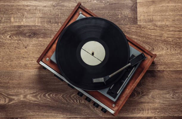 istock Retro vinyl record player with a record on the floor. 80s. Top view 1219972344