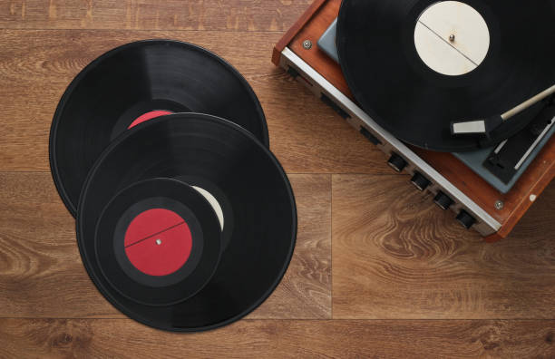 istock Retro vinyl record player with a records on the floor. 80s. Top view 1219972352