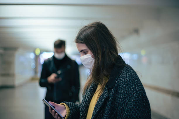 istock group of residents in protective masks walking in the underpass 1219973285