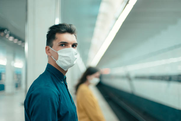 istock passengers in protective masks standing at a metro station at a safe distance 1219973304