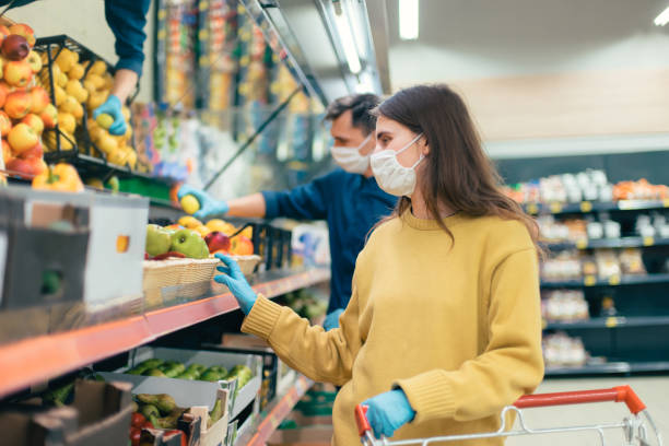 istock young woman in a protective mask buys apples 1219973395