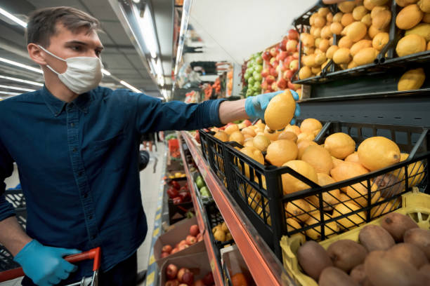 istock man in protective gloves takes a lemon from a grocery counter 1219973500