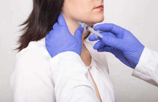 Taking a biopsy from a girl from the salivary gland to check for a benign or malignant tumor, cancer Taking a biopsy from a girl from the salivary gland to check for a benign or malignant tumor, cancer, therapy salivary gland surgery stock pictures, royalty-free photos & images