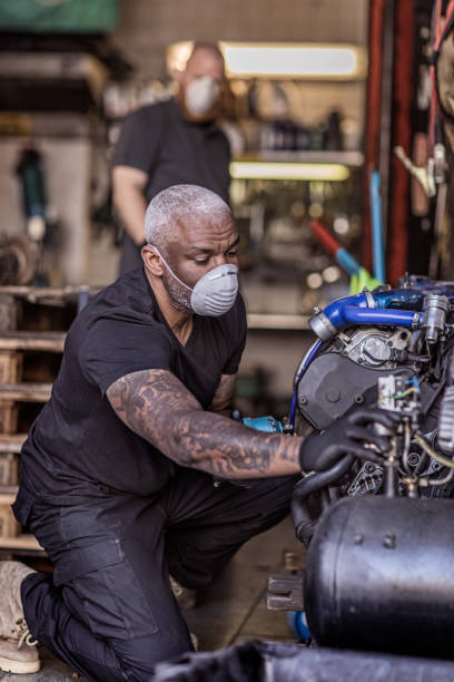 istock Two male mechanic essential workers wearing a face mask each during virus outbreak 1219978285