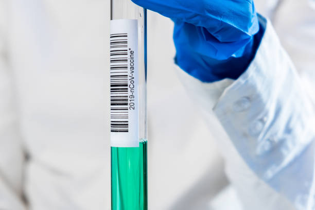 istock Virus and vaccine for SARS-CoV-2, coronavirus causing COVID-19 disease, tubes in doctor's hands 1219978494