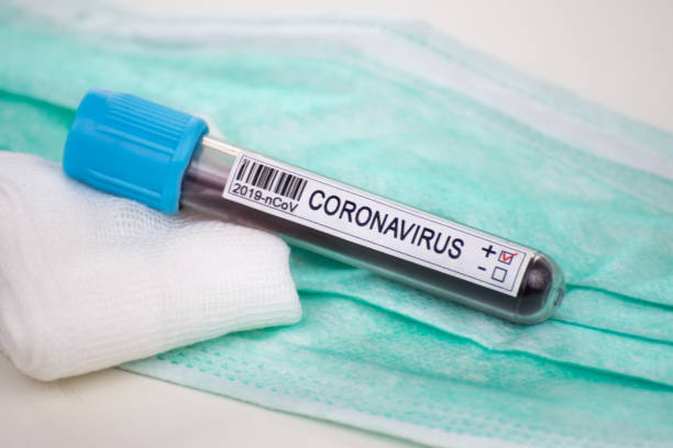 istock Blood sample for coronavirus test and protective mask 1219981296