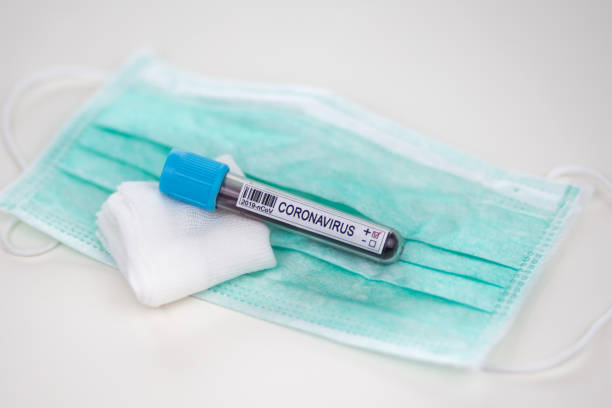 istock Blood sample for coronavirus test and protective mask 1219981326