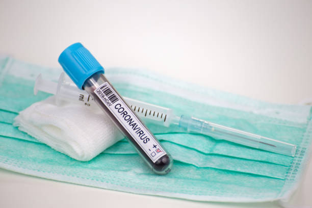istock Blood sample for coronavirus test and protective mask 1219981371
