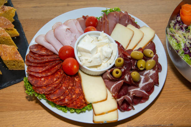 istock Slices of different sausage, ham and salami 1219981461