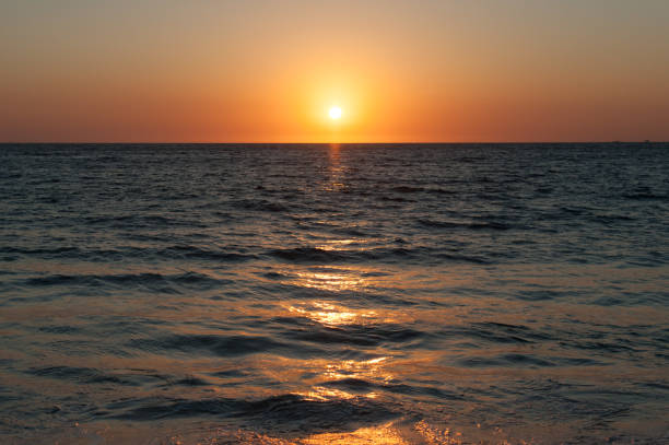 istock Orange sun setting over dark water in Mexico on Pacific Coast 1219981956