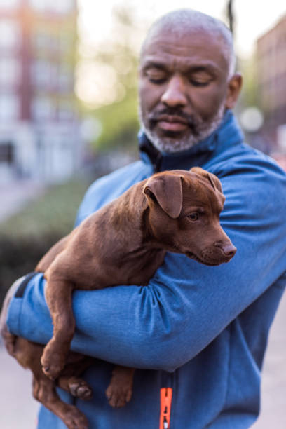 Handsome black man with a puppy