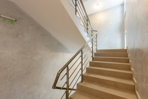 istock Modern stair case between floors. Stairs with metallic rail  in modern building 1219983785